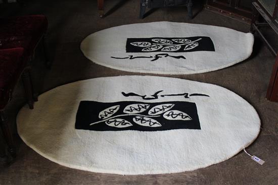 2 oval wool rugs with fern pattern